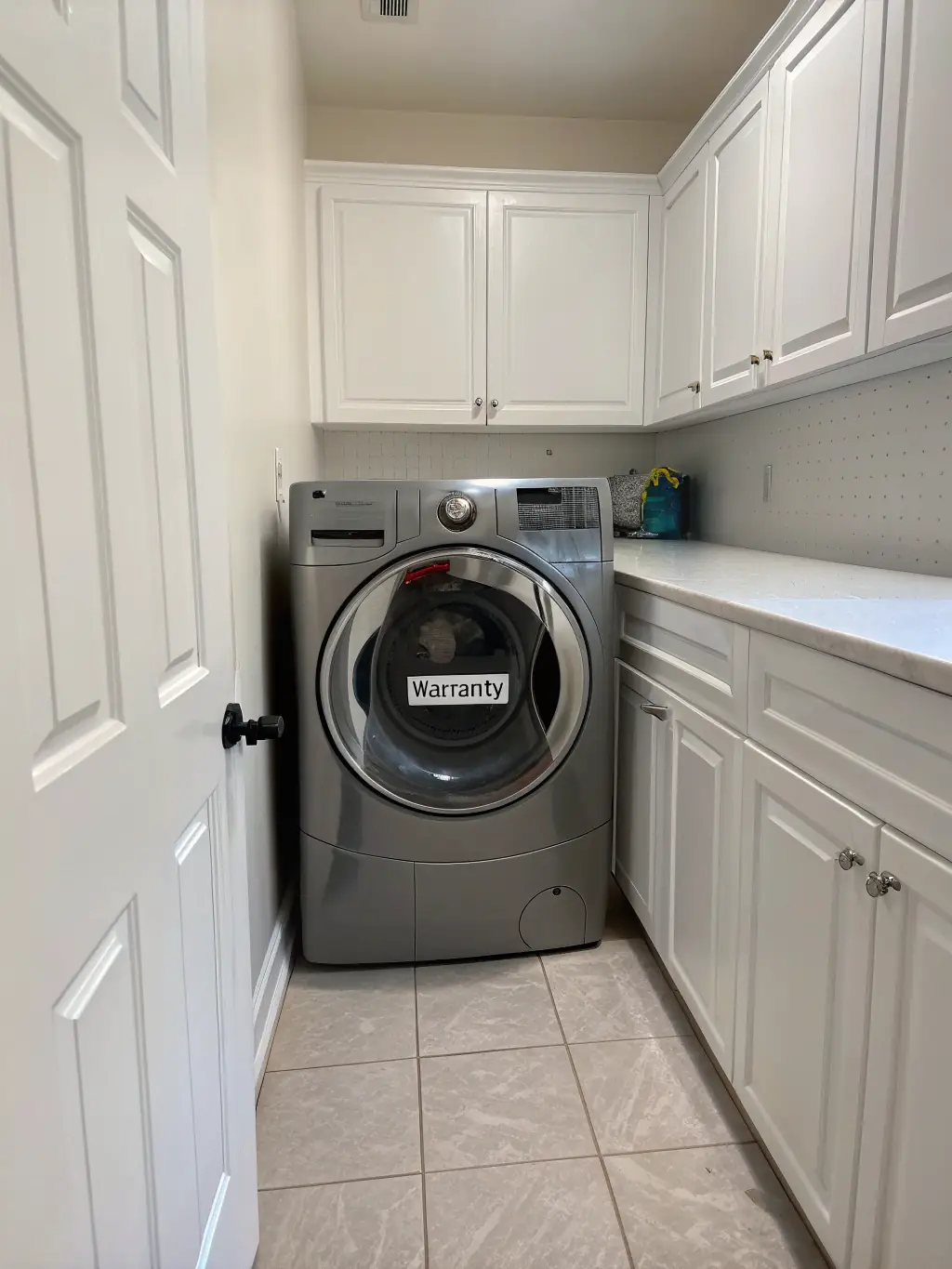A front-load washing machine with clothes being loaded into it. The laundry room is organized and functional, emphasizing the ease of doing laundry.